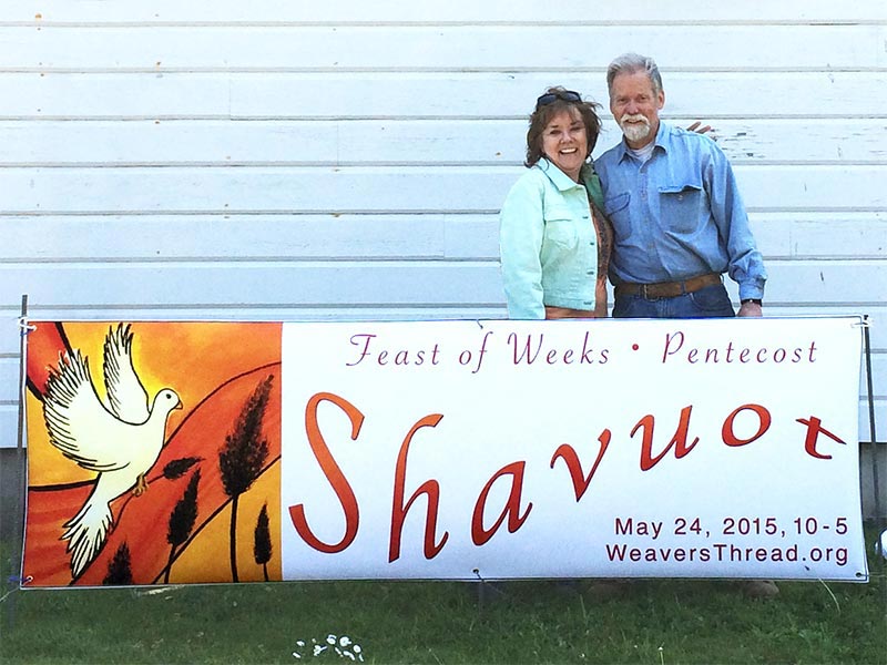 Helen and Aubby putting up signs for Shavuot